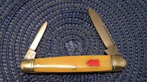 Schatt & Morgan Titusville PA. Yellow Pen Knife with Red Shield