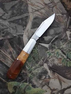 Kroo Custom handmade Barlow pattern knife with Clip Point Blade and Sneezewood Burl Scales.