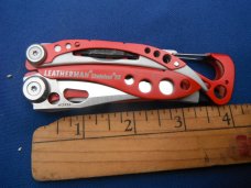 Red Leatherman Skeletool RX Carabiner Multi-Tool Pliers, Serrated Knife with Original Nylon Sheath Red Leatherman Skeletool RX Carabiner Multi-Tool Pliers, Serrated Knife with Original Nylon Sheath