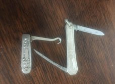 LADIES FINE BUTTON HOOK AND A SILVER MANICURE KNIFE
