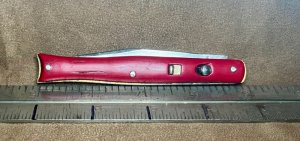 Bright red EdgeMaster automatic fishtail knife. 
