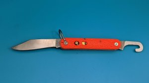 Camillus New York Paratrooper Emergency Rescue Knife. Orange Jigged Delrin Handles, Steel Shackle.