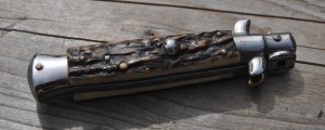 Rostfrei Thick Gnarly Stag Button Open Bolster Close 6 1/8" Overall 2 1/8" Flat Ground Blade Fast