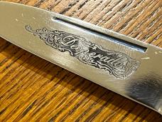 Parker Cut. Co. Desperado Scrimshawed Single-Blade Lockback Knife w/MOP Scales & Engraved Bolsters Parker Cut. Co. Desperado Scrimshawed Single-Blade Lockback Knife w/MOP Scales & Engraved Bolsters