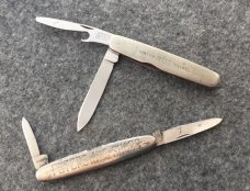 Two Metal Frame Advertising Knives 