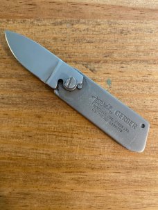 Gerber touché belt buckle knife wood grain and scrimshaw fish