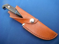 Custom handmade fixed blade knife with leather sheath.  A very sharp edge.