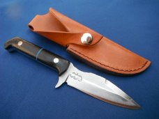 Custom handmade fixed blade knife with leather sheath. A very sharp edge.