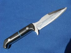 Custom handmade fixed blade knife with leather sheath.  A very sharp edge.