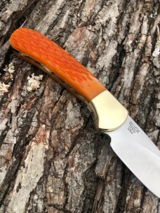 BUCK 113 CUSTOM LEROY REMER ORANGE JIGGED SKNNER