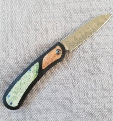 Johan Ellis Lion 4",Damasteel with Giraffe Bone inlays and Paper Micarta Frame over G10 and titanium