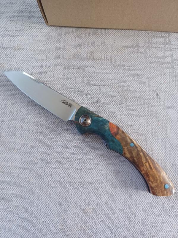 Johan Ellis Springbok...4",Karilian Bolsters..Amboyna scales...G10 and titanium frame.Rwl34..coa 