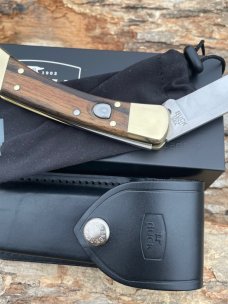 BUCK 110 AUTO BRASS BOLSTER WITH SHEATH & BOX