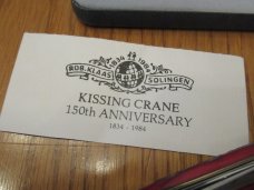 Kissing Crane 150th Anniversary Red Jigged Bone Sleeveboard Whittler 1834 to 1984