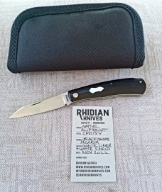 Rhidian Shadow Native...Black Linen micarta. .Cpm154..4" cld..white liners and white Shield.. coa