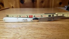 Great Eastern Cutlery 65 Ben Hogan Smooth White Bone Knife New, Mint Condition with Tube and button.