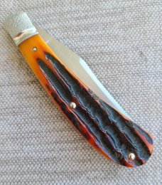 Jennings Trapper..Magnacut blade..Amber Bone..Jeweled bolsters..liners & shield..coa & box. 3.75"