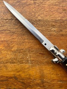 11 In. Italian Swivel Bolster,  Black Composition, Stainless Bayonet, SwitchBlade