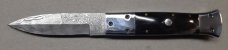 Hand made damascus switchblade with buffalo horn handles.