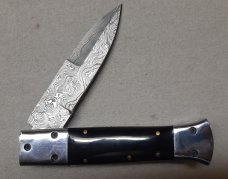 Hand made damascus switchblade with buffalo horn handles.