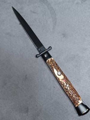 11" Stag scales Italian Stiletto swinguard. Frank Beltrame Dagger Teflon coated blade. Flat button.
