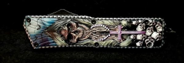 OTF Reaper with skulls in 3D relief and in color. 