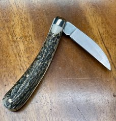 A Wright & Son "Ettrick" Carving Knife with Stag Handles and Curved Wharncliffe Blade