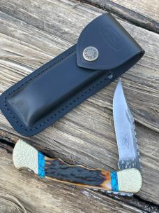 BUCK 110 FINGER GROOVE LEROY REMER CUSTOM AMBER STAG KNIFE