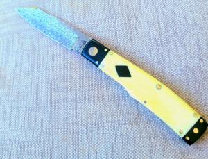 K'roo Native.. 4"..Black Linen bolsters&caps..Warthog Tusk Ivory Scales..red accents..Damasteel