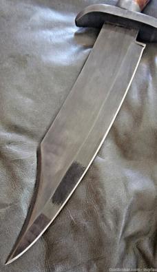 Burnished Stainless Steel Bowie knife with leather sheath.