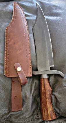 Burnished Stainless Steel Bowie knife with leather sheath.