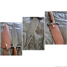 Burnished Stainless Steel Bowie knife with leather sheath.