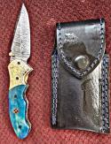 Damascus hand made hand forged folding knives. Blue with Engraved bolster. Ambidextrous. 