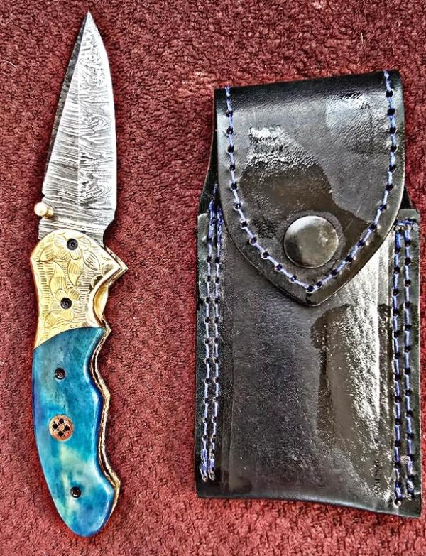 Damascus hand made hand forged folding knives. Blue with Engraved bolster. Ambidextrous. 
