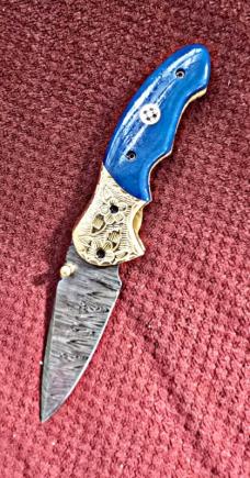 Damascus hand made hand forged folding knives. Blue with Engraved bolster. Ambidextrous. 
