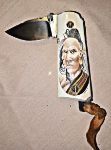 BASKETT Custom knife. Colt 45 grips with custom SCRIMSHAWED American Indian design on Mammoth tusk