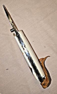 BASKETT Custom knife. Colt 45 grips with custom SCRIMSHAWED American Indian design on Mammoth tusk