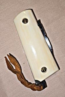 BASKETT Custom knife. Colt 45 grips with custom SCRIMSHAWED American Indian design on Mammoth tusk