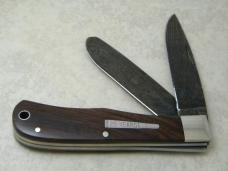 Remington USA R1128 2007 25th Anniv. Cocobola Damascus Silver Bullet Trapper Knife in Tin