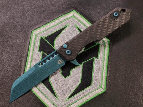 Heretic Jinn Button Lock Flipper Metallic Teal MagnaCut Carbon Fiber Handles Heretic Jinn Button Lock Flipper Metallic Teal MagnaCut Carbon Fiber Handles