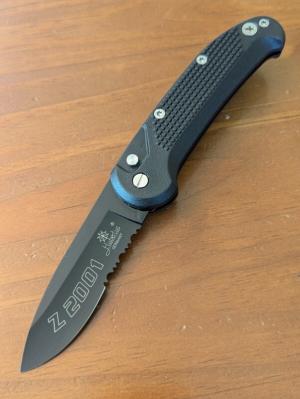 HUBERTUS TACTICAL Z2001 BLACK ON BLACK SERRATED DROP POINT BLADE ZYTEL POLYMER SCALES COIL SPRING