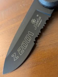 HUBERTUS TACTICAL Z2001 BLACK ON BLACK SERRATED DROP POINT BLADE ZYTEL POLYMER SCALES COIL SPRING