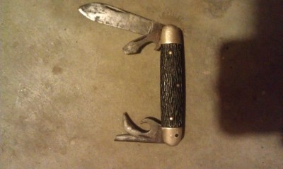 Whole knife view: main blade, a can opener, a thing that looks like another can opener, and a broken blade that looks like it might've been like a leather punch or awl.
