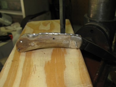 i use my drill press to push down the spring to accept the pin.