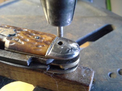 I wanted to re-use the brass (what I am calling) bail tube so I pressed it out with a 3/32" stainless rod. Used the drill press as a press instead of a drill.