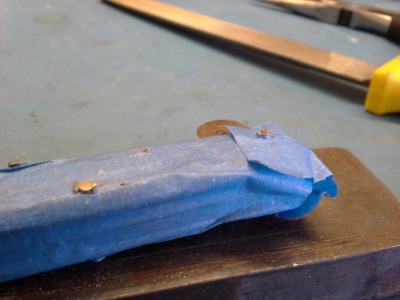 Filed the heads of the pins flat. I found that it's best to have them flat before peening. I also filed them so there was only about half the diameter of the pin left above the bolsters.
