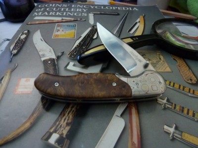 Kershaw Nakamura with VG-10 blade and Quince wood handle. Multilayer metal bolster.
