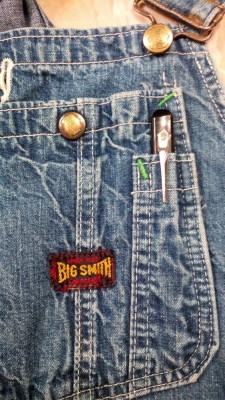 Slide knife in bib overall pocket