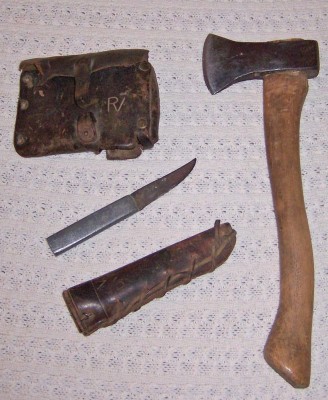 This is the hatchet &amp; knife with sheaths all made by my granddad. The backdrop to the photo is a quilt crocheted by my grandmother. 
<br />Grandpa put his initials on the sheath, RV.