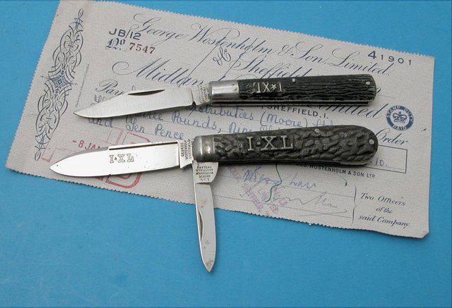 # 2 Pair of IXL knives. Metal handled relief handles Two blade 3 3/8” swell end jack and Doctors knife. Both mint except for some age specks Includes an original check from George Wostenholm &amp; Son, Ltd.